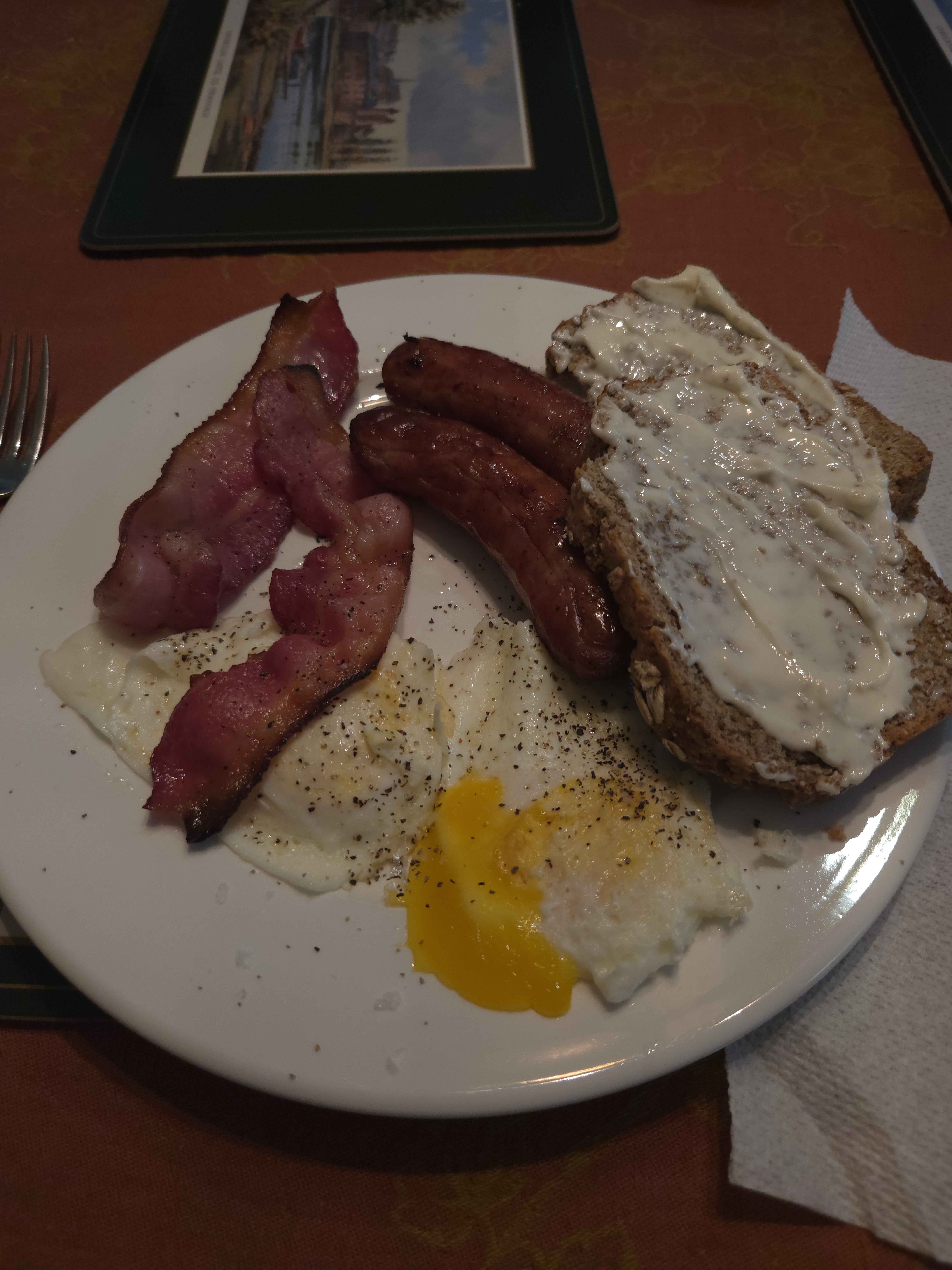 Fried eggs bacon sausages toast